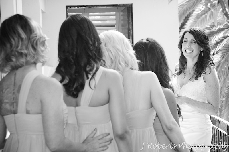 Bride laughing back at her bridesmaids - wedding photography sydney